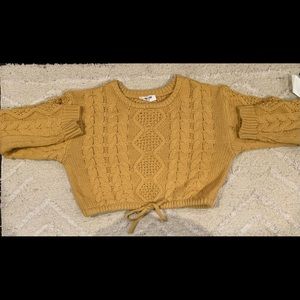 A yellow knit sweater